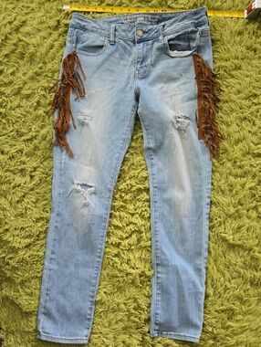 American Eagle Outfitters Light Blue Skinny Jeans with Brown Fringe
